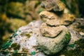 Vertical pile stones uneven close-up tower folded gray stone forest design