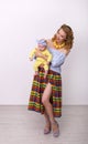 Vertical pin-up photo of a young pretty woman with a baby in her arms Royalty Free Stock Photo