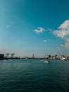 Vertical of the port of Genova in Italy under the blue sky with fluffy clouds