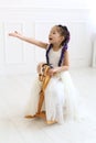 Vertical portrait of an active five year old girl in a white studio Royalty Free Stock Photo