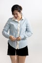 Vertical portrait of asian business woman measuring waist size with tape measure,worried female employee with bigger belly,unhappy Royalty Free Stock Photo