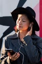 Vertical portrait of an asian woman with earphones Royalty Free Stock Photo