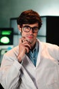 Vertical portrait of attractive medical doctor with glasses and lab coat looking at camera. Front view of handsome Royalty Free Stock Photo