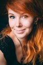 Vertical portrait of a beautiful red-haired curly girl with make-up and jewelry Royalty Free Stock Photo