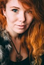 Vertical portrait of a beautiful red-haired curly girl with make-up and jewelry Royalty Free Stock Photo