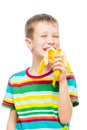 vertical portrait of a boy who eats a tasty banana on a white background