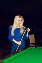 Vertical portrait of a charming blonde rubbed cue chalk Royalty Free Stock Photo