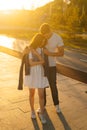 Vertical portrait of charming young couple in love hugging in summer evening on background of warm sunlight. Royalty Free Stock Photo