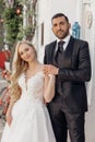 Vertical portrait cheerful and romantic married couple, blond woman, black-haired man on wedding ceremony. Holiday party Royalty Free Stock Photo