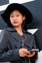 Vertical portrait of a chinese girl with earphones Royalty Free Stock Photo