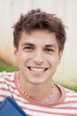 Vertical Portrait of close young man quite smiling looking happily in the outdoor chamber. Royalty Free Stock Photo