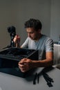 Vertical portrait of computer technician disassembling desktop pc, wielding precision screwdriver while recording Royalty Free Stock Photo