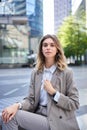 Vertical portrait of confident businesswoman in suit, adjust her blazer, looks self-assured. Candidate waits for an