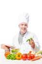 Vertical portrait of a cook at the table with book Royalty Free Stock Photo