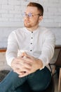 Vertical portrait of good-looking confident young business man in elegance eyeglasses wearing stylish white clothes Royalty Free Stock Photo