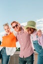 Vertical portrait of a group of young adult people having fun together at summer weekend party. Front view of three Royalty Free Stock Photo