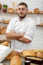 Young man working at his bakery