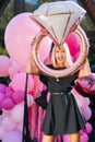 Vertical portrait of happy fun blonde female in summer dress holding various colorful festive foil helium balloons Royalty Free Stock Photo