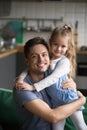 Vertical portrait of happy kid daughter embracing father at home Royalty Free Stock Photo