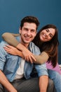 Vertical portrait of happy young couple in love, cudding and relaxing in their modern apartment. Smiling wife embracing Royalty Free Stock Photo