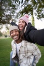 Vertical Portrait of happy young multiethnic couple taking a selfie. Beautiful girlfriend having fun