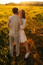Vertical portrait of happy young woman with closed eyes and man in love embracing, kissing, stroking standing together Royalty Free Stock Photo
