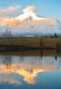 Vertical Portrait Landscape of Snowy Mountain Peak and Dramatic Clouds reflected in Blue Water of Nature Lake in Canadian Rockies Royalty Free Stock Photo