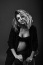 Vertical portrait of a lovely young pregnant woman in a pantsuit Royalty Free Stock Photo