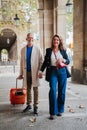 Vertical portrait of a mature couple sightseeing on a romantic journey trip in Spain. Middle aged married people walking