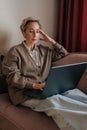 Vertical portrait of pensive Caucasian middle-aged business woman think business idea solution, working remotely, do Royalty Free Stock Photo