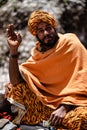 Vertical portrait of a pilgrim giving blessings outside the Muktinath Temple, Nepal