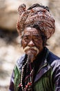 Vertical portrait of a pilgrim giving blessings outside the Muktinath Temple, Nepal