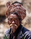 Vertical portrait of a pilgrim giving blessings outside the Muktinath Temple, Nepal