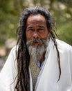 Vertical portrait of a pilgrim giving blessings outside the Muktinath Temple, Nepal