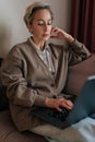Vertical portrait of pondering elegant middle-aged businesswoman think business idea solution, working remotely, do Royalty Free Stock Photo