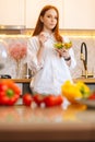 Vertical portrait of pretty attractive young redhead woman eating fresh vegetarian salad enjoying fresh tasty vegetables Royalty Free Stock Photo