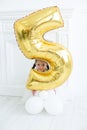 Vertical portrait of a pretty five year old girl in a white studio Royalty Free Stock Photo