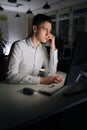 Vertical portrait of IT programmer checking computer code using desktop. Busy developer working late writing software Royalty Free Stock Photo