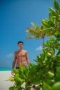 Vertical portrait shot of a man on the beach at the tropical island luxury resort Royalty Free Stock Photo