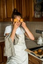 Vertical portrait.Smiling teen girl taking cookies out of the oven in the kitchen.Homemade cakes, cookies and gingerbread cookies Royalty Free Stock Photo