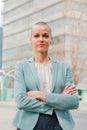 Vertical portrait of successful business woman standing arms crossed at workplace looking at camera. Corporate female Royalty Free Stock Photo