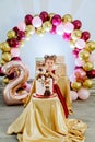 Vertical portrait of sweet two year old little girl standing behind her birthday cake and making a wish Royalty Free Stock Photo