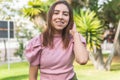 Vertical portrait of a teenage girl with braces smiling in a park and teasing her light straight hair Royalty Free Stock Photo