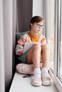 Girl With Down Syndrome Daydreaming By Window Royalty Free Stock Photo