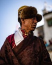 Vertical portrait of a Tibetan Buddhist village elder in traditional clothes at the Tiji Festival