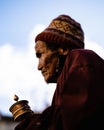 Vertical portrait of a Tibetan Buddhist village elder in traditional clothes at the Tiji Festival
