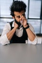 Vertical portrait of tired exhausted Indian businessman massaging nose bridge, taking off glasses, feeling eyestrain Royalty Free Stock Photo