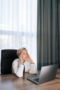 Vertical portrait of tired middle-aged business woman using laptop having problem, upset about mistake at workplace Royalty Free Stock Photo