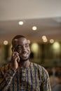 Vertical portrait traditional black African entrepreneur using phone