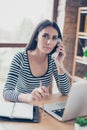 Vertical portrait of troubled secretary listening to her boss an